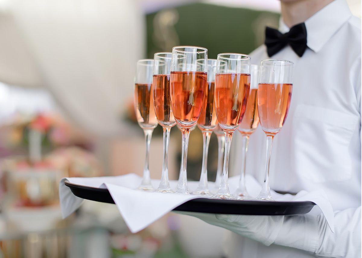 The Plaza Hotel Pioneer Park El Paso Exteriör bild A waiter holding a tray of champagne